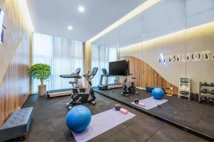 a gym with exercise equipment and a large glass wall at Atour X Hotel Xian Administration Center of North Railway Station in Xi'an