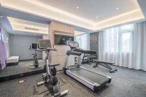 a gym with two exercise bikes in a room at Atour Hotel Taizhou Maoye World in Taizhou