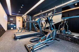 a gym with several cardio equipment in a room at Atour Changsha Xingsha in Changsha