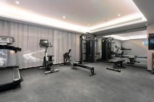 a gym with treadmills and machines in a room at Atour Hotel Wuhan Optics Valley Square Yangjia Bay in Wuhan
