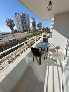 einen Balkon mit einem Tisch und Stühlen sowie Stadtblick in der Unterkunft Departamento Coquimbo - La Serena in Coquimbo