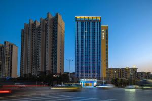 a city with tall buildings and a street with cars at Atour Hotel Basketball Nanchang West Station in Nanchang