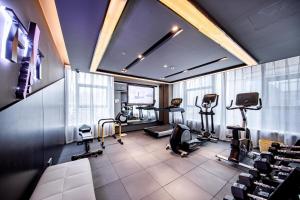 a man in a gym with exercise equipment in it at Atour Hotel Yuzhong Yuci Incity in Jinzhong