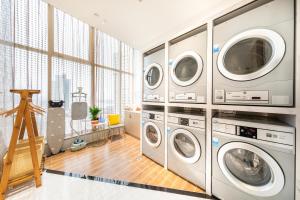 a laundry room with four washer and dryers at Atour Hotel Changde Laoximen in Changde