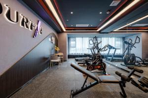 a gym with treadmills and exercise bikes in a room at Atour Hotel Jiaxing Pinghu in Pinghu