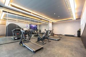 a gym with several exercise bikes and a television at Atour Hotel Zhengzhou East Station Longzi Lake in Zhengzhou