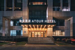 a hotel entrance with a sign that reads take elevator hotel at Atour Hotel Jiaxing Pinghu in Pinghu +22 photos