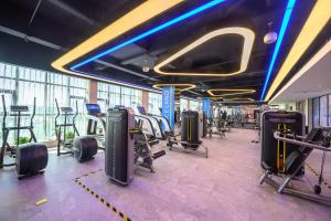 a gym with rows of treadmills and exercise bikes at Atour Hotel Dongguan Songhan Lake in Dongguan