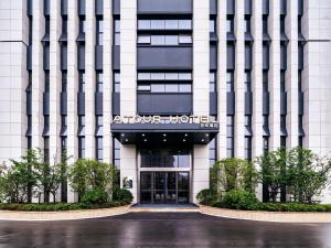 a building with the entrance to a hotel at Atour Hotel Nanjing Olympic Sports Center Tianhe Plaza in Nanjing