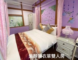 a bedroom with a white bed and a purple wall at Chambord Castle in Gukeng