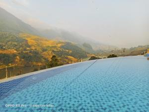 a large swimming pool with a view of a mountain at Sapa Eco Villas & Spa in Sapa