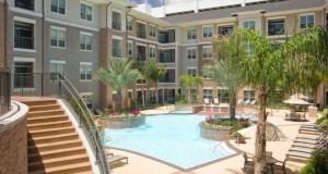 a swimming pool in front of a building at 2bedroom 1Bath 10 mins to Texas Medical in Houston