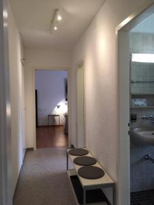 a bathroom with a bench next to a sink at 2 Zimmer mit Balkon, zentrale ruhige Lage in St. Gallen