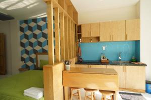 a kitchen with a counter with stools in a room at COCA HOTEL & APARTMENT in Vung Tau