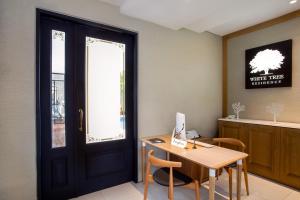 an office with a door and a desk with a computer at White Tree Residence in Jakarta