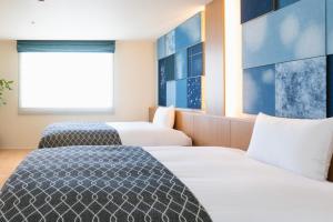 Postel nebo postele na pokoji v ubytování Nagi Kurashiki Hotel&Lounge