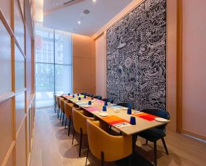 a conference room with a long table and chairs at Mercure Kuala Lumpur Glenmarie in Shah Alam