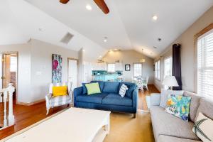 a living room with a blue couch and a table at Fish N' Ships in Waves