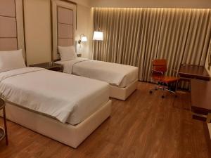 Postel nebo postele na pokoji v ubytování KAY-EM Spectra Hotel