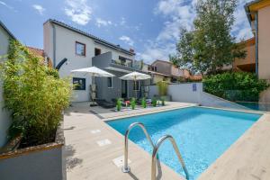 a swimming pool in the backyard of a house at Lounge house Dolce Vita in Pula