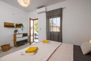 a bedroom with a bed with yellow towels on it at Lounge house Dolce Vita in Pula +65 photos