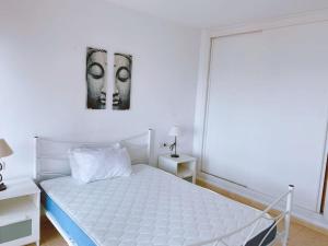 a bedroom with a white bed and a window at Amazing view in Playa den Bossa in Sant Josep de sa Talaia