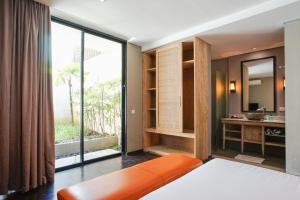 a bedroom with a bed and a large window at Villa Bima II in Nusa Dua +32 photos