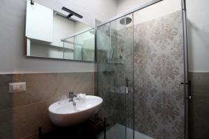 La salle de bains est pourvue d'un lavabo et d'une douche. dans l'établissement Il casale di Sandra, à Chiusi