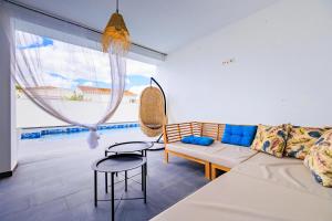 a living room with a couch and a large window at ViLLA MI SOL in Torrevieja +32 photos