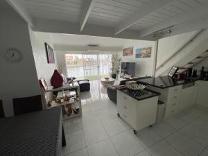 a kitchen and living room with a counter top at Port Lincoln Marina Waterfront Apartment in Port Lincoln