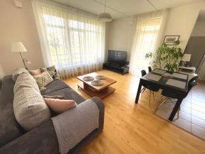 a living room with a couch and a table at Cozy Home Apartment Kaivas, free parking, self check-in in Rīga