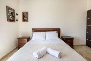 a bedroom with a bed with two pillows on it at Karpathos View Villa in Karpathos