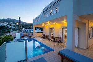 a house with a swimming pool on a balcony at Karpathos View Villa in Karpathos