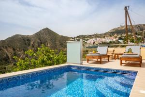 a swimming pool with a view of a mountain at Karpathos View Villa in Karpathos