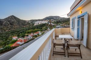 a balcony with a table and chairs and a view at Karpathos View Villa in Karpathos