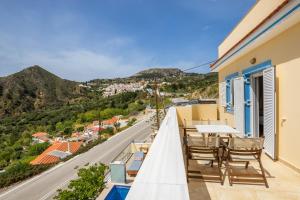 a balcony with chairs and a view of a city at Karpathos View Villa in Karpathos