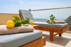 a room with two beds and a balcony with a view at Karpathos View Villa in Karpathos