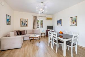 a living room with a couch and a table at Karpathos View Villa in Karpathos