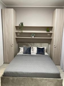 a bedroom with a large bed with blue pillows at Casa Vacanze Simeri Mare in Simeri Mare