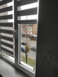 a window with a view of a street at Studio COMFORT on Golovna street in Chernivtsi