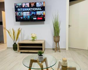a room with two tables and a tv on a wall at Casa Vacanze Simeri Mare in Simeri Mare