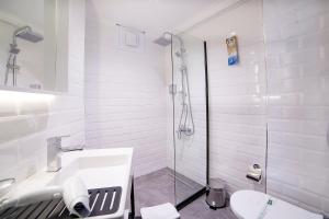 a bathroom with a shower, toilet and sink at Barin Hotel in Istanbul
