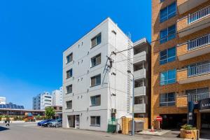 a white building on the side of a street at ORANGE in Sapporo