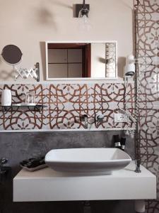 a bathroom with a sink and a mirror at Villa Blanche Dimora Di Charme in Marsala