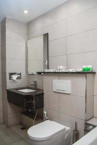 a bathroom with a toilet and a sink at Ngong Hills Hotel in Nairobi