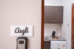 a sign that says exit on a wall in a kitchen at Esperides Studios in Sivota