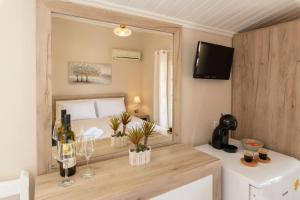 a bedroom with a bed and a large mirror at Esperides Studios in Syvota