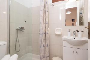 a bathroom with a shower and a sink at Esperides Studios in Syvota +37 photos