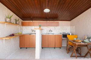 a kitchen with wooden cabinets and a table with a tableablish at Esperides Studios-Seaside Stay with View in Syvota in Syvota