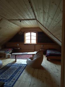 a room with a table and a couch in a attic at Horpyna in Krempna